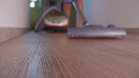 Unrecognizable person using vacuum cleaner on carpet at home Stock Footage 123312798