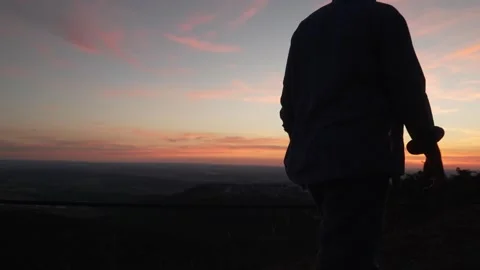 Unrecognizable person walking toward sunset and stopping at scenic viewpoint Stock Footage 341826169