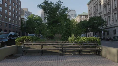 An unrecognizable person walks by an empty bench on New York City's Broadway Stock Footage 280016407