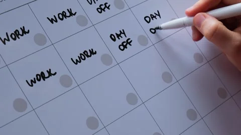 Unrecognizable person write on Magnetic board 4 day work week calendar with Stock Footage 244824001