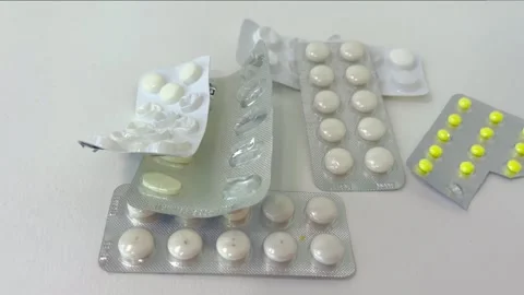 Unrecognizable person's hand taking pills from various blister packs, illus.. Stock Footage 335141502