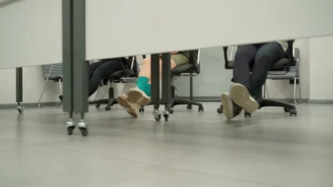 Unrecognizable persons in multi-colored socks on chairs. Shot with motion Stock Footage 162554731