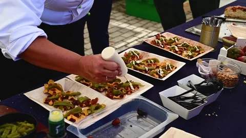 Unrecognizable professional chef sauces some dishes for showcooking Stock Footage 213209131