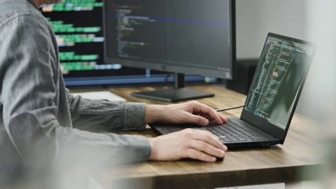 Unrecognizable programmer developer, writes code. Modern workplace with powerful Stock Footage 173043683