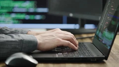 Unrecognizable programmer developer, writes code. Modern workplace with powerful Stock Footage 174868184