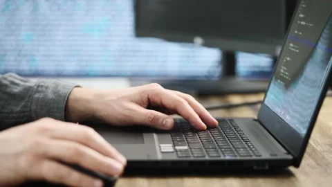 Unrecognizable programmer developer, writes code. Modern workplace with powerful Stock Footage 183244787