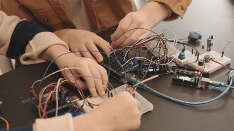 Unrecognizable Pupils Constructing Robots in Classroom Stock Footage 153464801