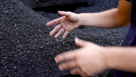 Unrecognizable road worker hands detail showing warm mix asphalt Stock Footage 253231222
