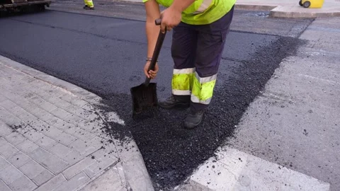 Unrecognizable road worker treating warm mix asphalt in road paving 2 스톡 동영상 253231218
