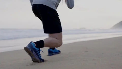 Unrecognizable runner starting sprint at the beach Stock Footage 242158640