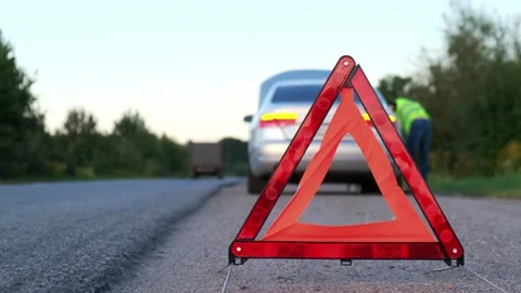 Unrecognizable sad driver in reflective vest. Male driver standing near broken Stock Footage 255006599