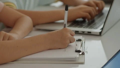 Unrecognizable Schoolboy Doing Test on Paper during Computer Class Stock Footage 280535791