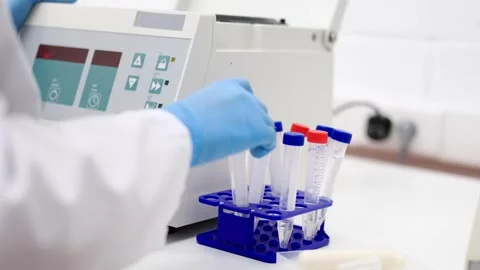 Unrecognizable scientist introducing samples in centrifuge machine Stock Footage 255196111