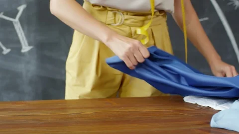 Unrecognizable Seamstress Transferring Pattern Markings on Fabric Stock Footage 97249701