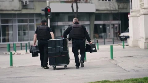 Unrecognizable security personnel dressed in protection vasts and uniform are Stock Footage 310333953