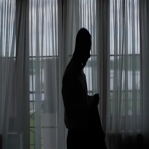 Unrecognizable silhouetted man puts jacket and buttons prepare to go slow motion Stock Footage 69396672