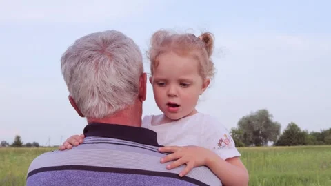 Unrecognizable silver-haired man with his small granddaughter enjoying the fresh Видео 291393999
