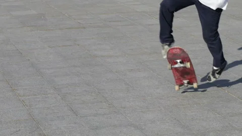 Unrecognizable Skater doing trick 360 kickflip on flat, close-up view, slowmo Stock Footage 96779607
