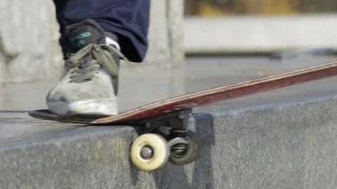 Unrecognizable skater doing trick nose slide on the street ledge of monument Video stock 96789085