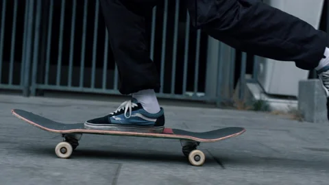 Unrecognizable skater jumping on longboard. Active man making kickflip outside. Stock Footage 158144567