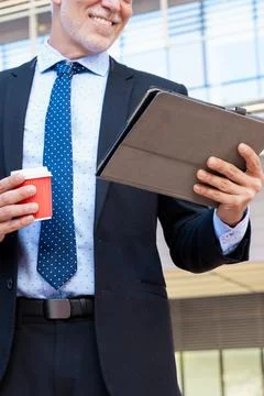 Unrecognizable smiling businessman using an app on his digital tablet .vertical Stock Photos