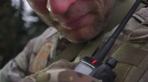Unrecognizable soldier in a camouflage talking on walkie-talkie. Close up video Stock Footage