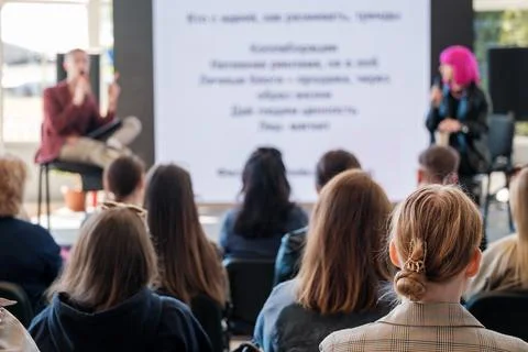 Unrecognizable speakers doing presentation on stage for group of participants Stock Photos