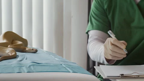 Unrecognizable Specialist Filling Form while Inspecting Python in Clinic Stock Footage 302233032