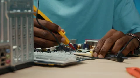 Unrecognizable Specialist Fixing Motherboard of Computer with Soldering Iron Stock Footage 300080110