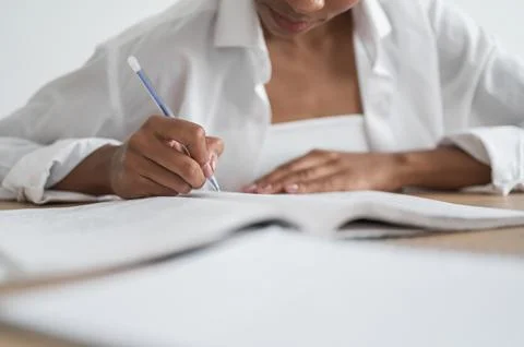 Unrecognizable Student preparing for college test, exam, writing notes, making Stock Photos