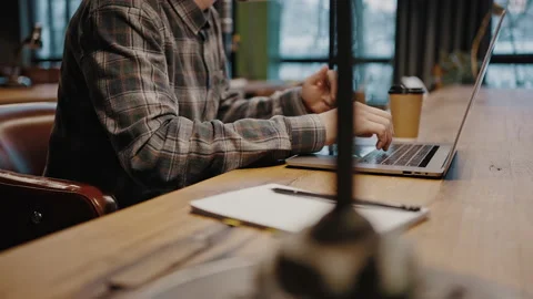 Unrecognizable student studying at library, making online research on laptop and Stock Footage 169706081