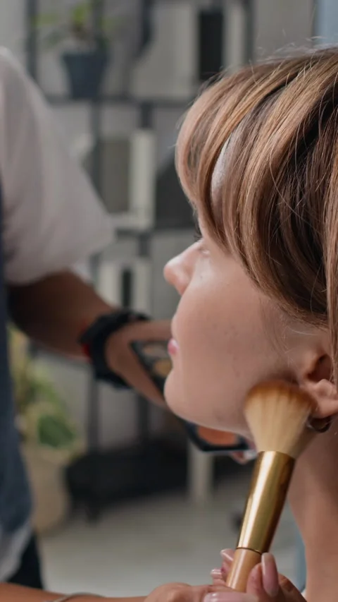 Unrecognizable Stylist Doing Make-Up for Young Actress for Filming Office Scene Stock Footage 305030871