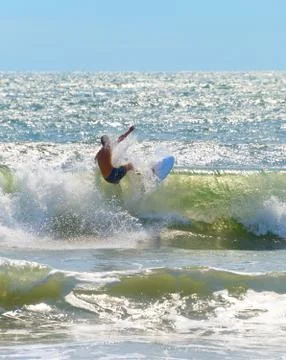 Unrecognizable surfer surf a wave Stock Photos