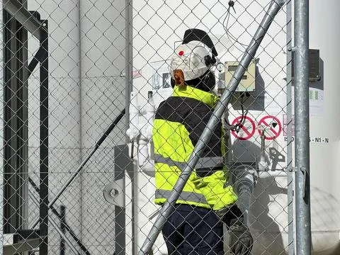Unrecognizable technician with work clothes fill with liquid nitrogen with Stock Photos