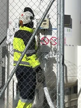 Unrecognizable technician with work clothes fill with liquid nitrogen with Stock Photos