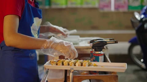 Unrecognizable Thai female working at flea market in Chiang Mai preparing sushi Stock Footage 221717824