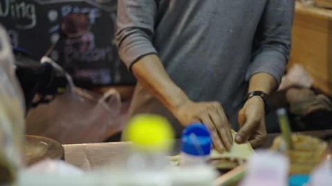 Unrecognizable thai man hands preparing a rotee dough Stock Footage 234977906