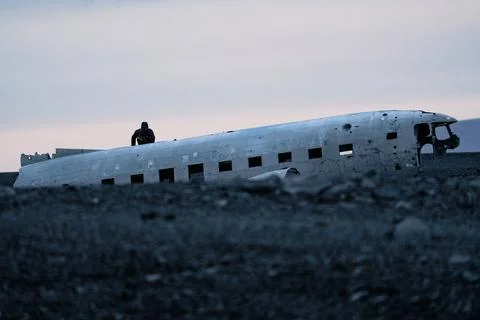 Unrecognizable tourist going down from the wreck of airplane Stock Photos
