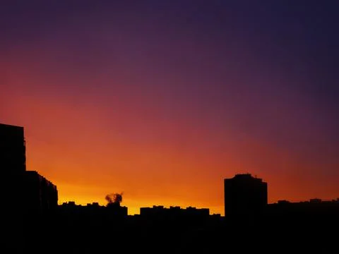 Unrecognizable, typical, multi-storey house on the background of sunset Stock Photos