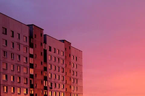 Unrecognizable, typical, multi-storey house on the background of sunset Stock Photos