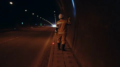 Unrecognizable view from the back worker in a white hard hat inspecting the Stock Footage 235185335