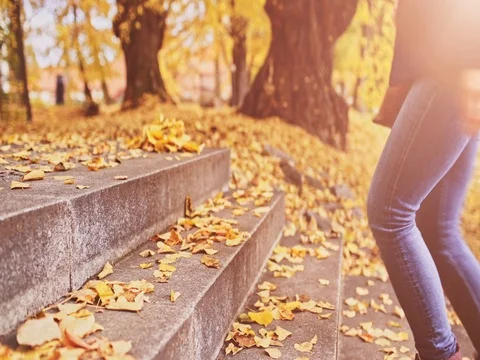 Unrecognizable Woman Feet walking the Stairs in Autumn. 4K DOLLY SHOT Close Up Stock Footage