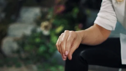 Unrecognizable woman hand snaps fingers in rhythm in park Stock Footage