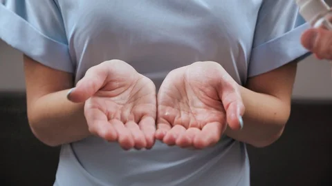 Unrecognizable woman hands get sprayed with hand sanitizer during the COVID-19 p Stock Footage 126861823