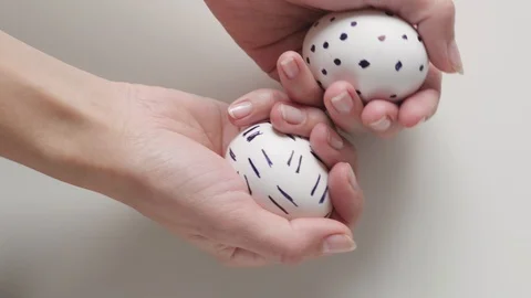 Unrecognizable woman holding an egg with a pattern in her hands. Easter eggs Stock Footage 108324411