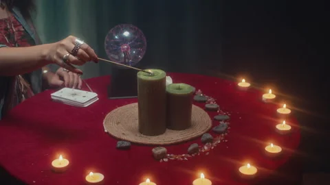 Unrecognizable Woman Lighting Candle in Centre of Ritual Table Stock Footage 253179958
