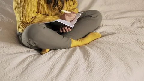 Unrecognizable woman makes notes in a notebook. Hand writes.. Woman makes plans Stock Photos