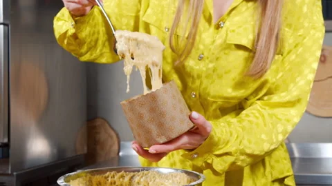 Unrecognizable woman preparing delicious Easter cakes putting dough in a mold Video stock 153479310