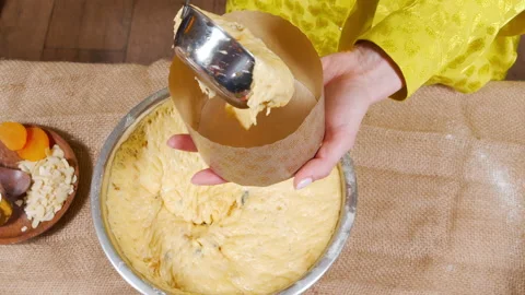 Unrecognizable woman preparing delicious Easter cakes putting dough in a mold Stock Footage 153527904