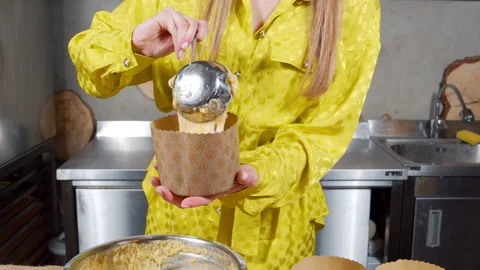 Unrecognizable woman preparing delicious Easter cakes putting dough in a mold Video stock 153692909